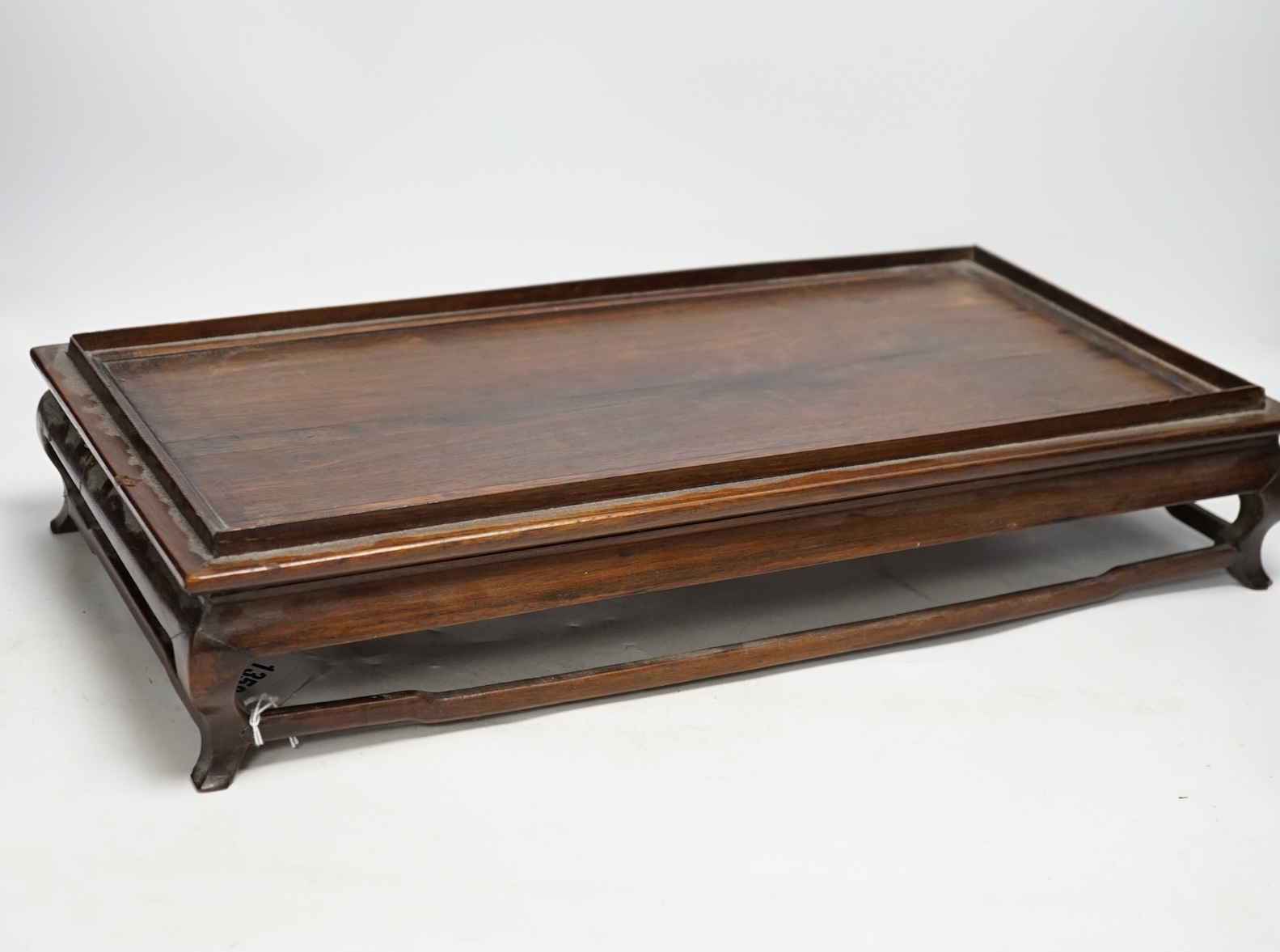 A 19th century Chinese rosewood rectangular stand, 48.5cm wide, 26cm deep, 10cm high. Condition - fair to good